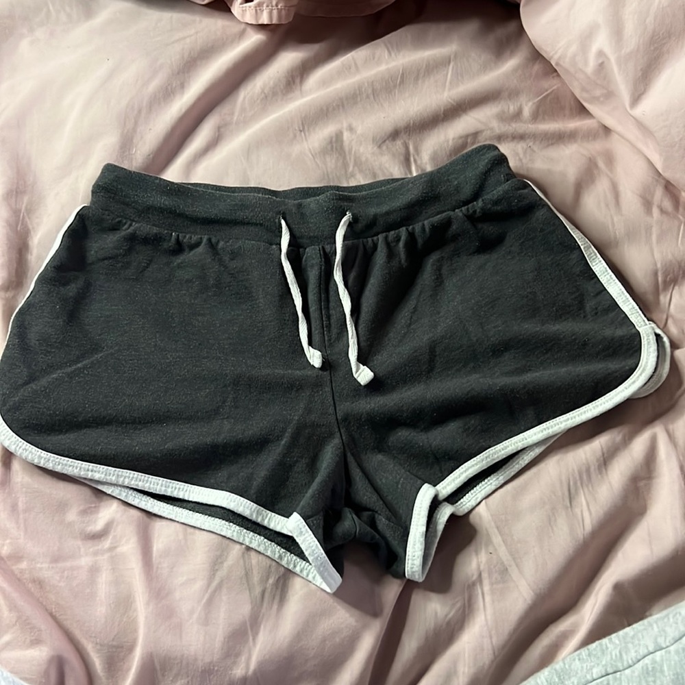 Dark grey small shorts white white stitching and strings.